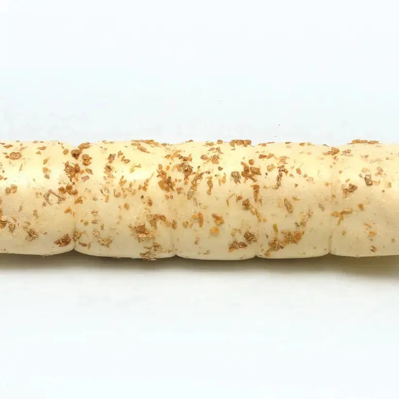 A close-up of Advance Pet Products All Natural Water Buffalo Cheek Roll Chews for Tough Chewers, their golden, crunchy texture promoting dental health in dogs, is shown against a plain white background.