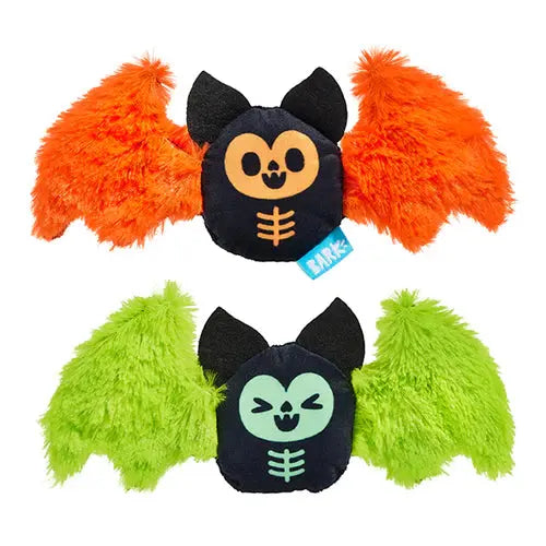 The BARK Flutter & Fang Plush Dog Toy by BARK features two Halloween bat toys—one orange, one green—with black ears, stitched faces, and fuzzy wings, perfect as squeaky or chew toys for small dogs.