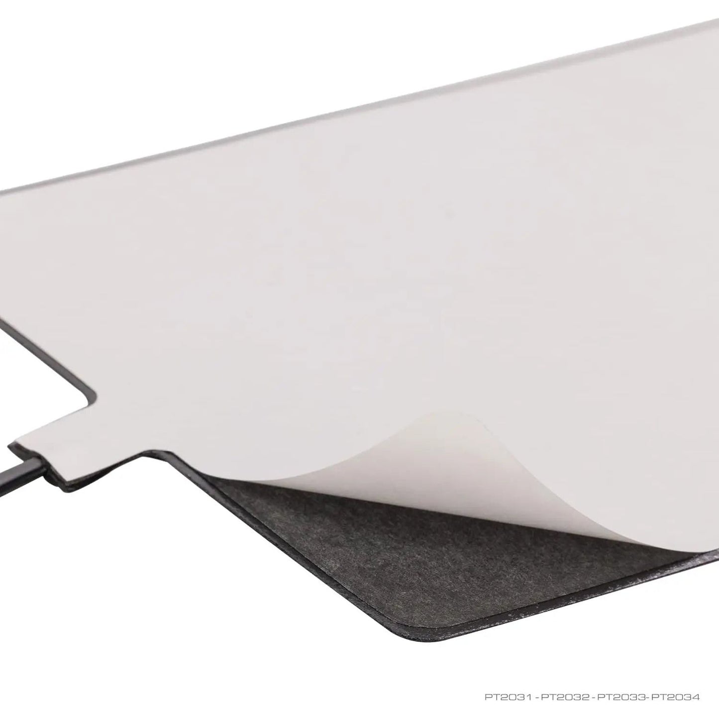 A close-up of the Exo Terra Self-Regulating Heat Mat for Reptiles & Amphibians shows one corner peeled back to reveal its gray underside and adhesive tab, set against a white background.