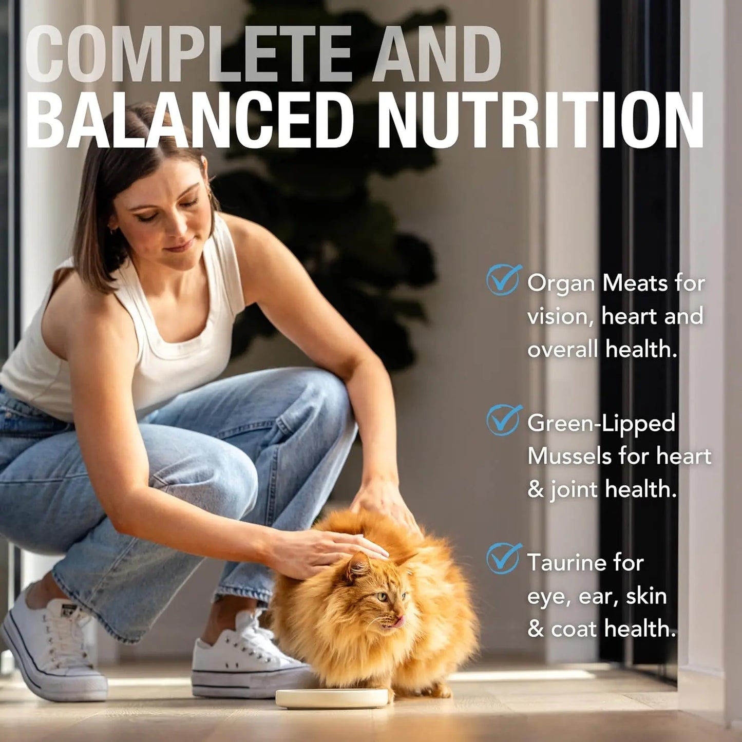 A woman crouches by an orange cat eating Feline Natural Beef Feast Grain-Free Canned Cat Food. Text notes: organ meats aid vision, mussels support joints, and taurine boosts eye, ear, skin & coat health.