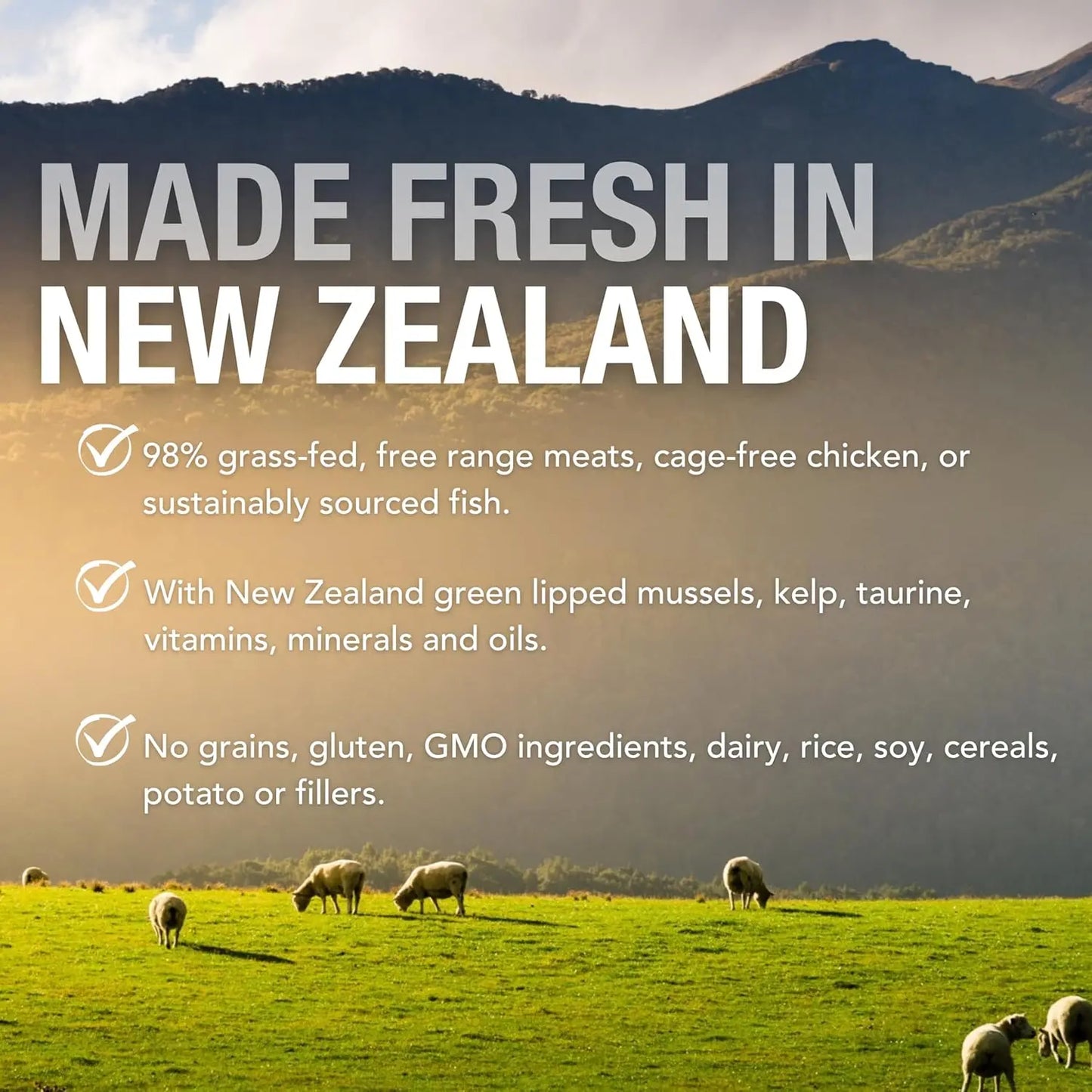 Sheep graze on lush grass before mountains—just like Feline Natural’s Beef & Hoki Feast Grain-Free Canned Cat Food, made in New Zealand with fresh, grass-fed beef and no grains, gluten, fillers, or artificial additives. Pure goodness for your cat.