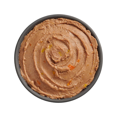 A black bowl of Go! Solutions Booster Brain Health Tuna & Salmon Pate Wet Cat Food by Petcurean Pet Foods, featuring smooth brown pâté with orange and yellow bits, viewed from above on a white background.