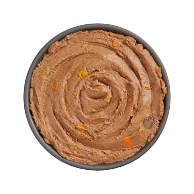 A black bowl with Petcureans Go! Solutions Booster Immune Health Tuna Pate Wet Cat Food—grain-free, featuring brown swirled tuna pâté and visible orange and yellow veggies—supports your cat’s immune health.