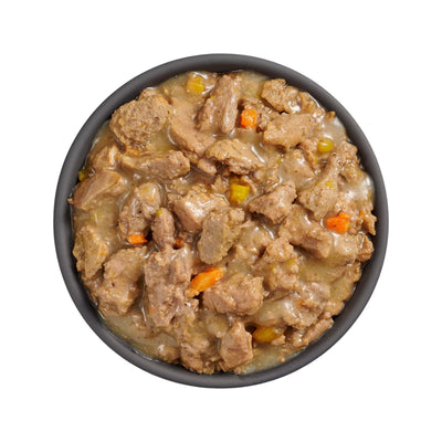 A black bowl with Go! Solutions Booster Weight Management Minced Chicken & Tuna with Gravy Wet Cat Food by Petcurean Pet Foods, featuring lean protein chunks and veggies in thick gravy, photographed from above on a white background.