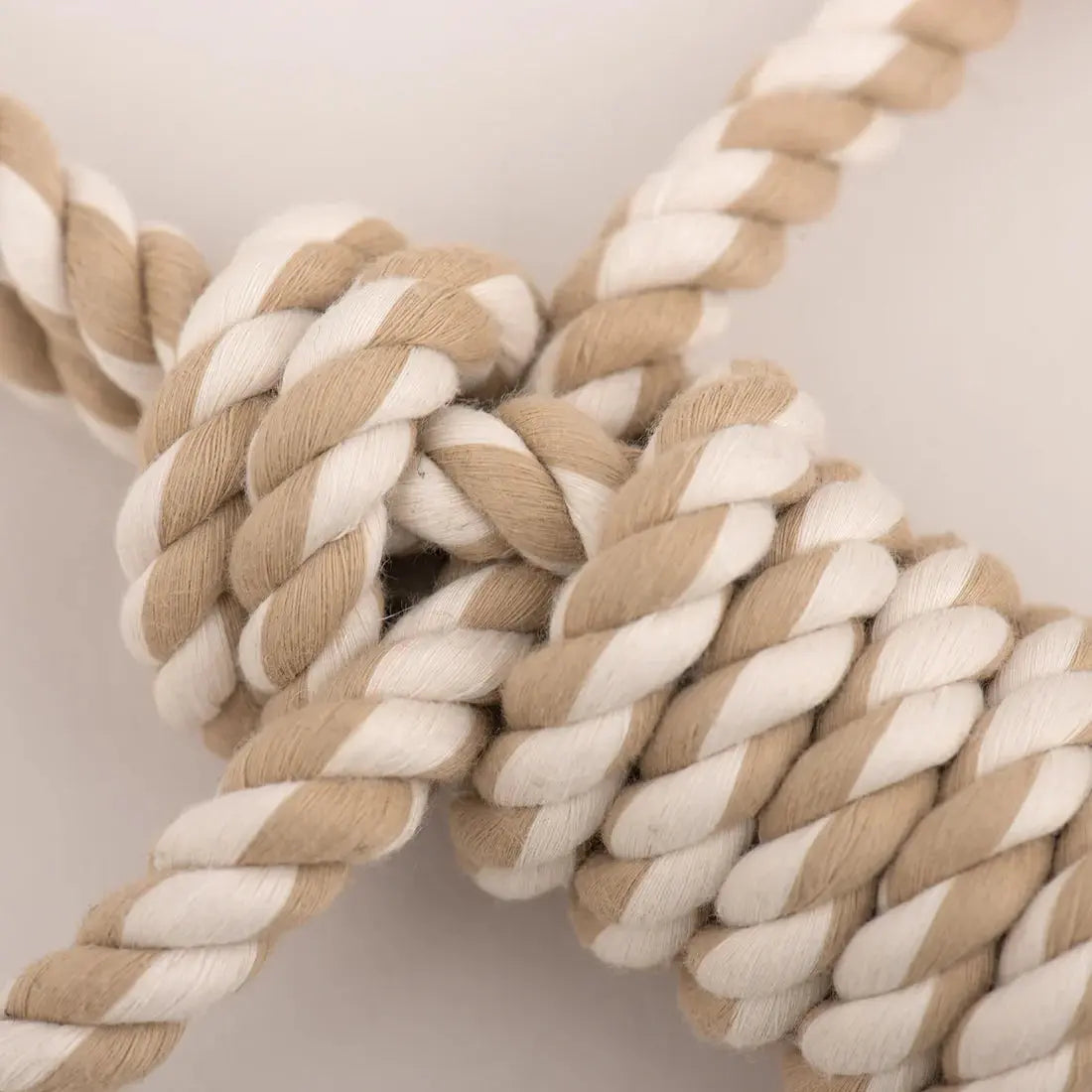 The HuggleHounds Birch Bunny X-Brace Tough Squeaky Plush Dog Toy by HuggleHounds features durable, beige and white twisted rope in a secure knot—perfect for pups who love to chew. Ideal for interactive and long-lasting play.