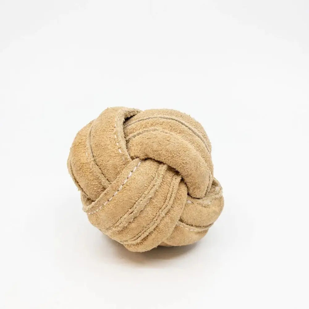 The HuggleHounds HuggleHide Natural Leather Ball Dog Toy rests on a white background. Made from interwoven, stitched natural leather strips, this durable toy from HuggleHounds is perfect for pups who love to chew.