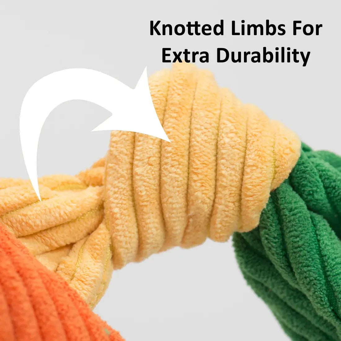 Close-up of HuggleHounds Rainbow Durable Plush Corduroy Knotties Squeaky Dog Toy’s orange and green knotted limbs, with text: Knotted Limbs For Extra Durability and a white arrow—a tough HuggleHounds chew toy built to last.