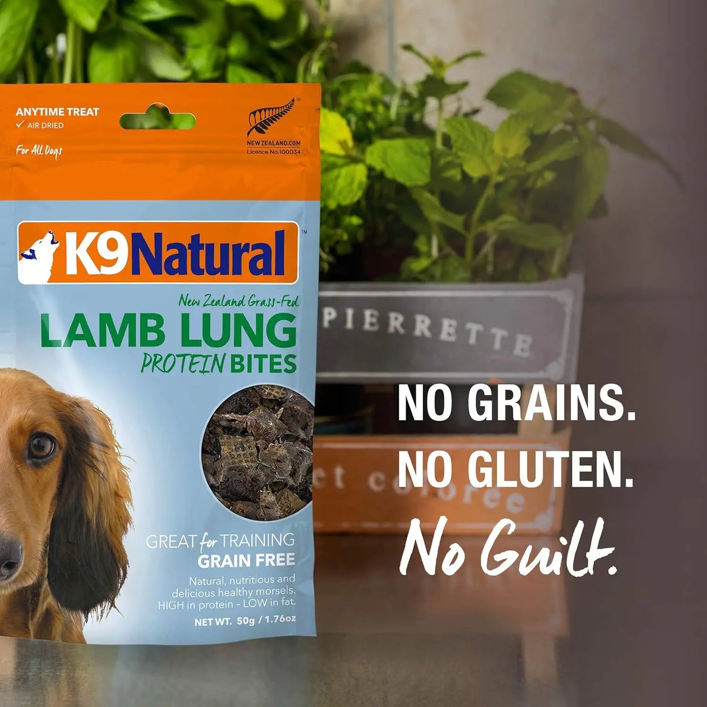 K9 Natural Beef Lung Protein Bites Air-Dried Dog Treats (2.1oz) are shown beside potted plants, with “No Grains. No Gluten. No Guilt.” highlighting these grain-free treats made from grass-fed New Zealand beef by K9 Natural.