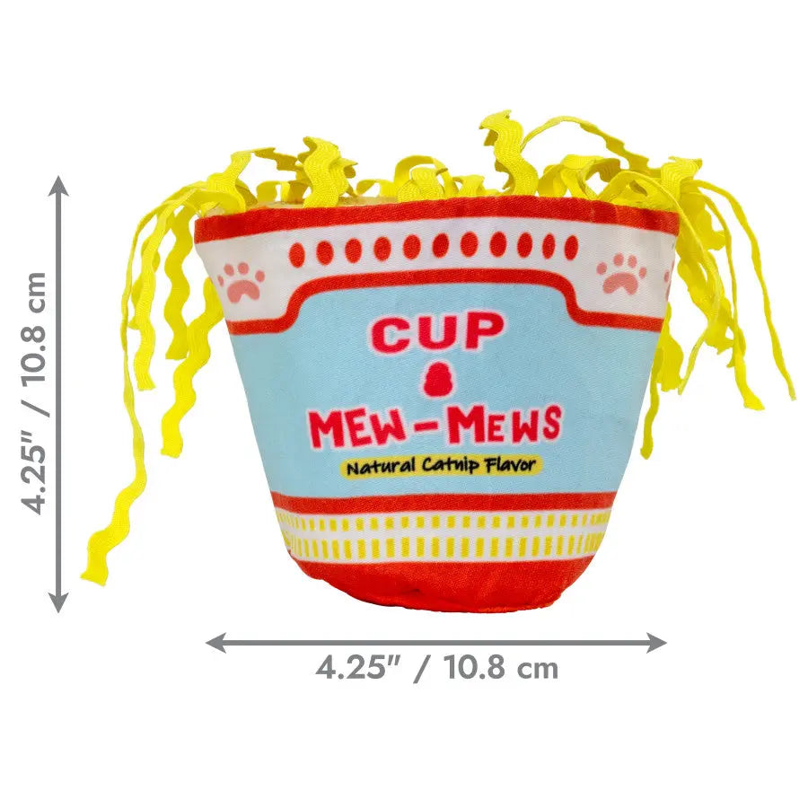 The KONG Crackles Cup of Mew-Mews Cat Toy by Kong resembles instant noodles with yellow fabric noodles on top. It measures 4.25 inches (10.8 cm) tall and wide and features a natural catnip flavor cats love.