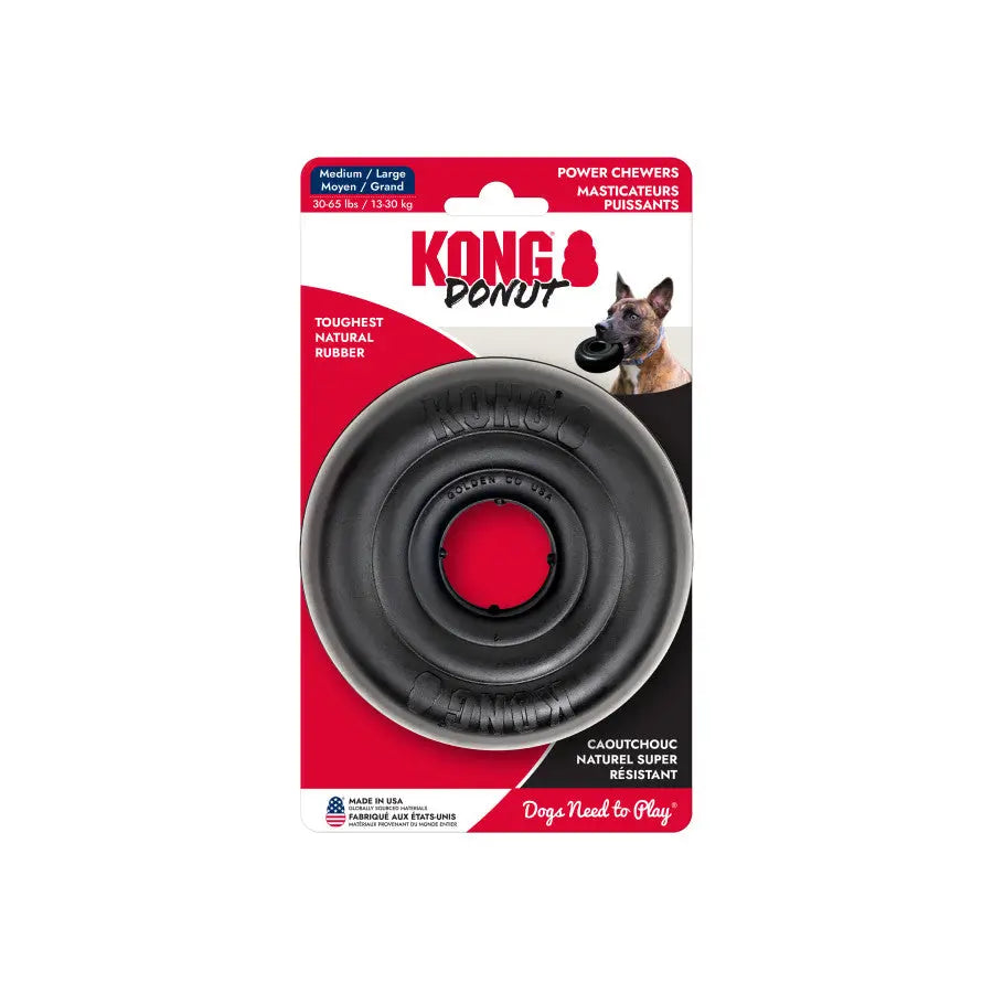 The KONG Extreme Donut Dog Toy by Kong is a medium/large, natural rubber toy in black packaging featuring a dog with the toy. Text highlights its extreme toughness and durability for the strongest chewers.