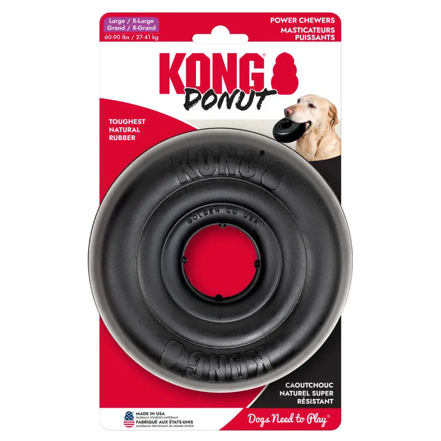 The KONG Extreme Donut Dog Toy by Kong is a black, tough natural rubber toy for power chewers. The packaging shows a dog with the toy and emphasizes its durability.
