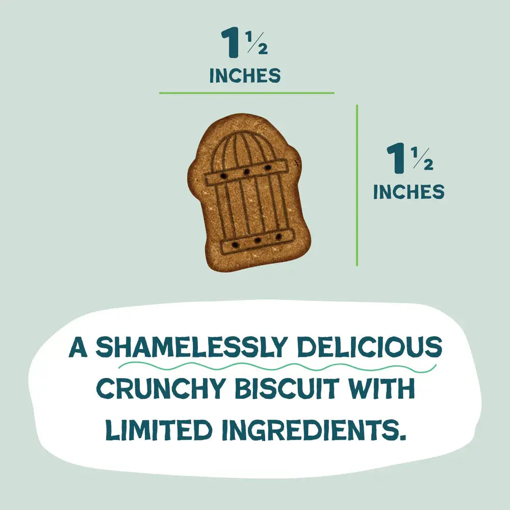 A 1.5-inch brown, gate-shaped biscuit is shown. Below, text reads: Shameless Pets Crunchy Bites Snack Mix Crunchy Dog Treats 10oz—shamelessly delicious with upcycled and limited ingredients.