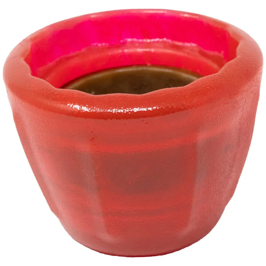 A small, round Starmark® Starmark Dental Treat Cookie Cup Jar Dog Toy in red, featuring a durable design and filled with a dark liquid, is shown from a slight angle on a white background.