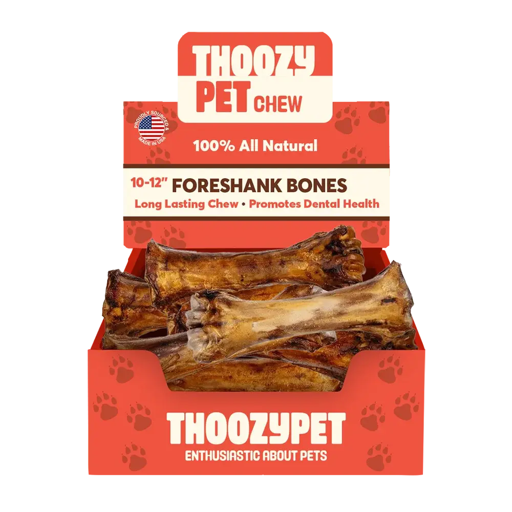 A red box labeled ThoozyPet contains 12 USA-sourced Foreshank Bone Dog Chews (10-12). The packaging promotes them as 100% all natural, great for dental health, and features an American flag in the corner.