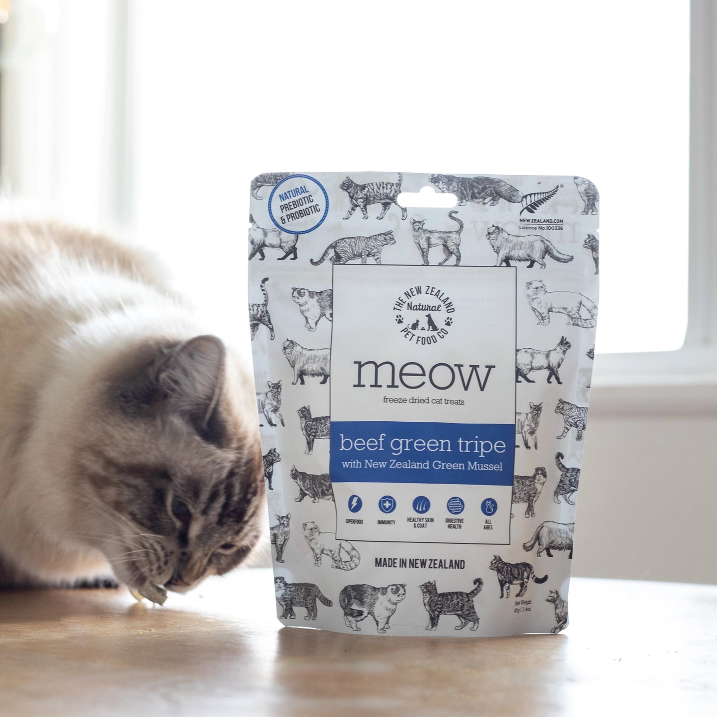 The New Zealand Natural Pet Food Co beef green tripe cat treats packaging with a cat enjoying a snack