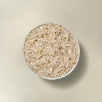 Petcurean grain free wet dog food for small breeds in a bowl with moist turkey chunks