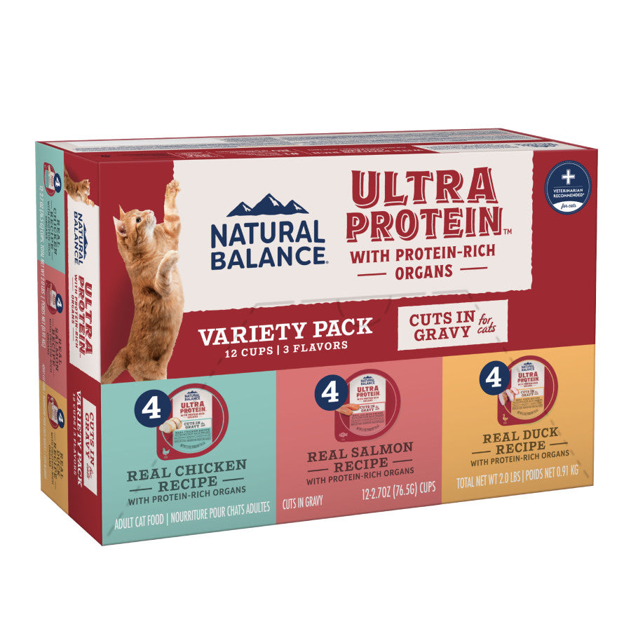 A box of Natural Balance Ultra Protein Cuts in Gravy Wet Cat Food, 10 cups (2.7 oz each), features protein-rich varieties and highlights nutritional benefits on the packaging with a cat image. Brand: Natural Balance.