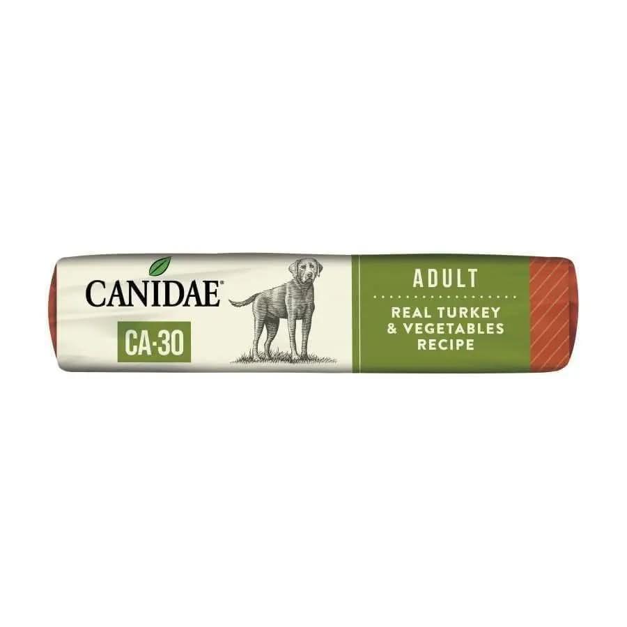 A bag of CANIDAE CA-30 Real Turkey, Peas & Carrots Recipe Dry Dog Food, featuring green and white packaging with a dog illustration.
