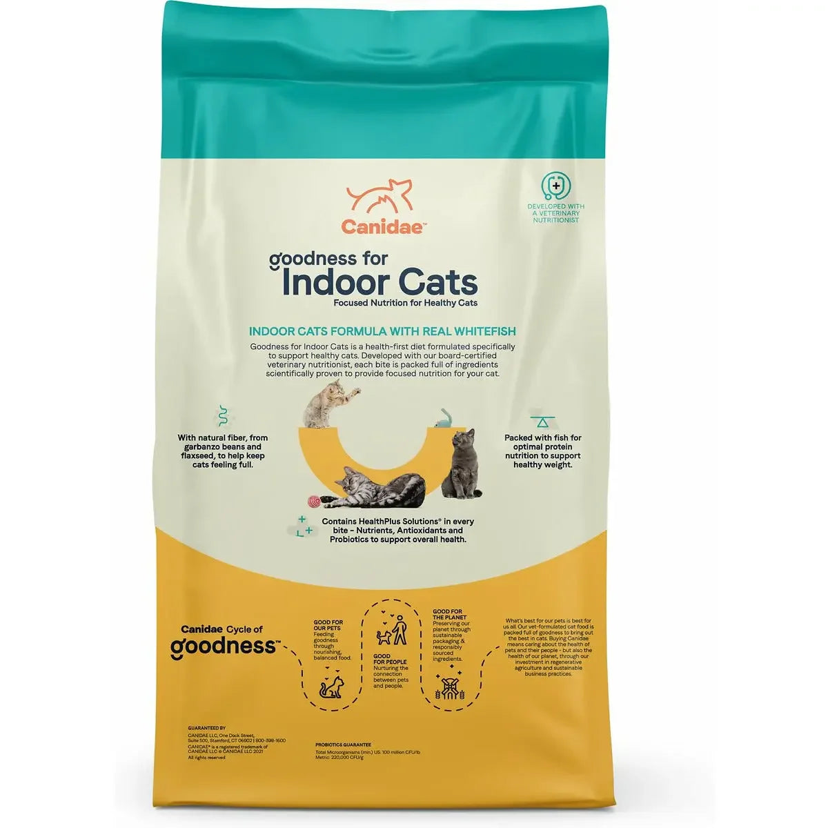 A bag of CANIDAE Goodness for Indoor Cats Formula with Real Whitefish Dry Cat Food showcases premium ingredients for adult cats in turquoise, yellow, and white packaging featuring cats and fish images.