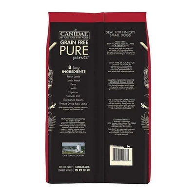 Back of a red CANIDAE PURE Grain-Free Petite Small Breed Adult Raw Coated with Lamb Freeze-Dried Dry Dog Food bag, showing 8 key ingredients and features, with white and black text on benefits and company details for this limited ingredient formula.