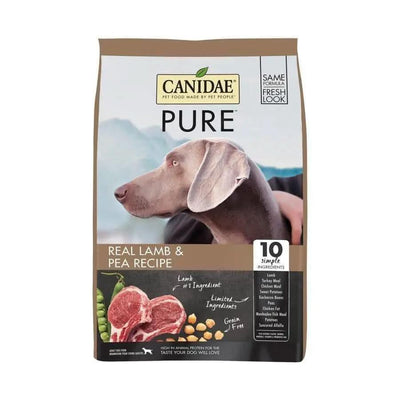 Bag of CANIDAE PURE Grain-Free Real Lamb & Pea Recipe Dry Dog Food featuring a gray dog looking sideways. The label highlights “10 Simple Ingredients” with images of lamb, peas, and chickpeas on the front.