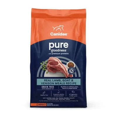 A bag of CANIDAE PURE Grain-Free Real Lamb, Goat & Venison Meals Recipe Good Dry Dog Food features adults’ nutrition in orange and blue packaging with raw meat and peas images, highlighting its grain-free formula.