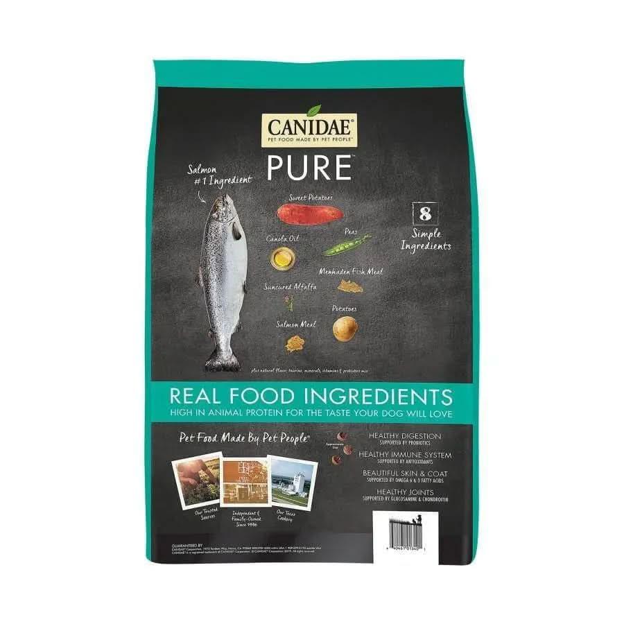 Front of a CANIDAE PURE Grain-Free Real Salmon & Sweet Potato Recipe bag shows a salmon image, ingredient list, and key benefits. The label highlights 8 simple ingredients for healthy digestion and coat in this limited ingredient dog food.