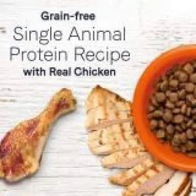 A chicken drumstick and sliced chicken breast are next to an orange bowl of CANIDAE Under The Sun Grain-Free Chicken Recipe Dry Dog Food. Text reads: Grain-free single animal protein with real chicken and farm-grown ingredients from CANIDAE.