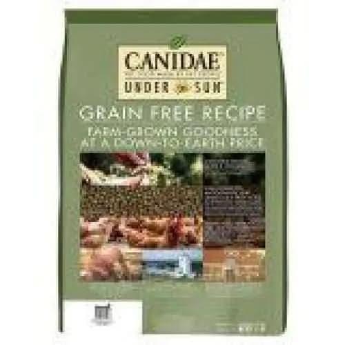 A green bag of CANIDAE Under The Sun Grain-Free Chicken Recipe Dry Dog Food, featuring images of crops and farm-grown ingredients, highlights this grain-free chicken recipe made with quality produce.