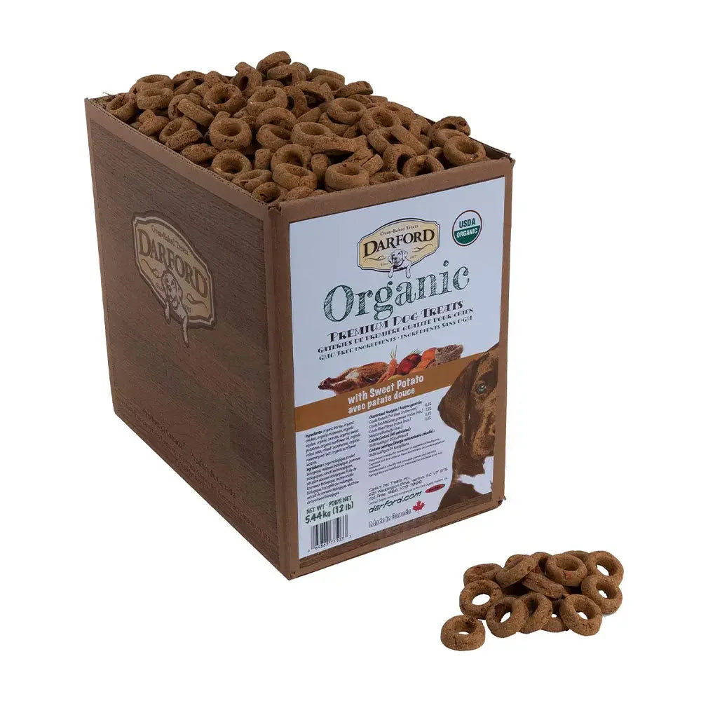 A wooden box filled with Darford® Organic Premium Sweet Potato With Chicken Dog Treats (12 lbs), with healthy ring-shaped treats scattered in front. The label features sweet potato flavor and organic certification from Darford.