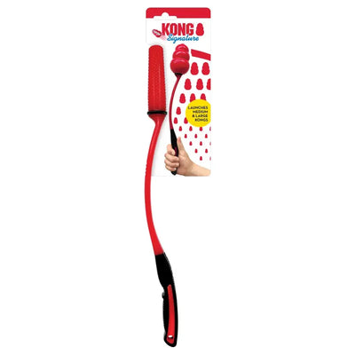 A red and black KONG Signature Ball Thrower for dogs lying on a surface