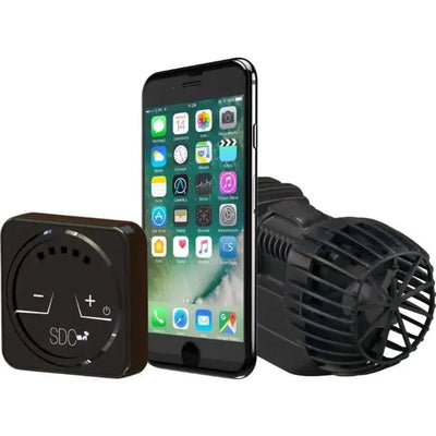 A smartphone sits between a compact controller and a black Sicce CPD XSTREAM SDC Controllable Wave Pump (270-2250 GPH) with grill, displaying the ContrALL App home screen for managing Wi-Fi aquarium devices.