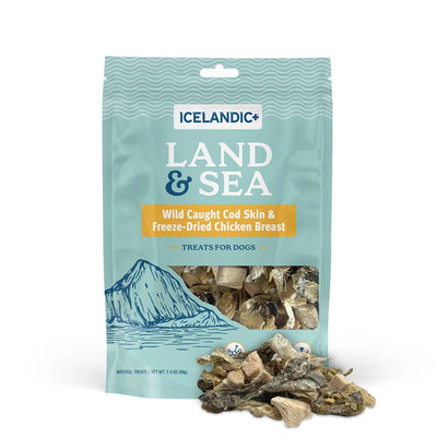 A blue 2.4 oz bag of Icelandic+ Land & Sea Cod Skin Freeze-Dried Chicken Dog Treats features wild-caught cod skin packed with omega-3s and freeze-dried chicken, mountain and sea graphics, visible treats inside, and some scattered in front.