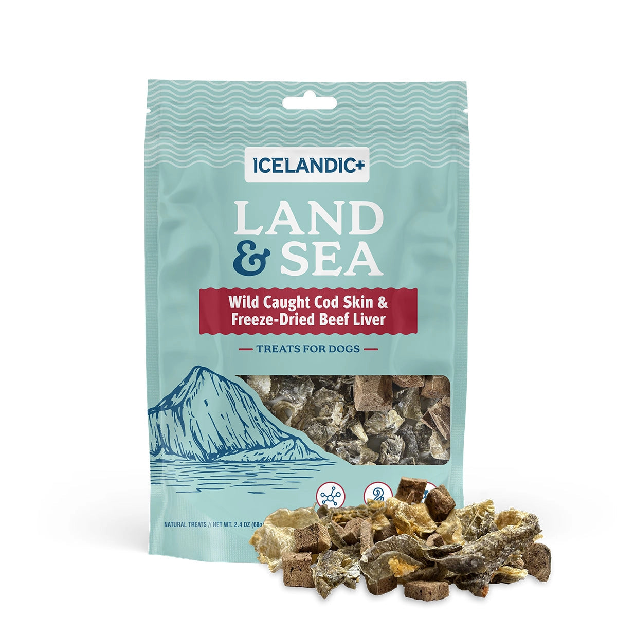 A teal Icelandic+ Land & Sea Cod Skin & Freeze-Dried Beef Dog Treat 2.4 oz bag features wild-caught cod skin and beef liver, with treats scattered in front and an illustration of a mountain and sea on the packaging.