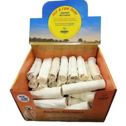 A box labeled Advance Pet Products All Natural Water Buffalo Cheek Roll Chews for Tough Chewers contains white chews, promotes dental health as a safe rawhide alternative, and features a dog image in the corner.