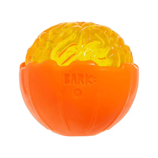 The BARK Pumpkin Prodigy Dog Chew Toy is an orange and yellow interactive toy shaped like a half-opened pumpkin with a brain design inside, featuring the word BARK and the letter M molded on its shell.