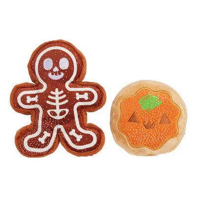 The BARK Spookie Cookies Plush Dog Toy by BARK includes a gingerbread skeleton and a plush pumpkin pie with a jack-o-lantern face, making it perfect for Halloween fun with your pup!.
