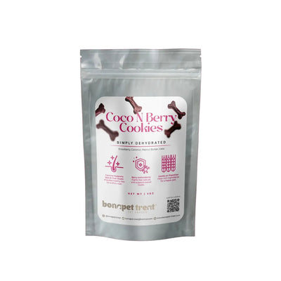 A silver resealable pouch labeled “Bonapet Coco N Berry Organic Dog Cookies 4 oz” by Bonapet Treat, featuring organic cookies with dehydrated strawberry, coconut, peanut butter, and oats; label shows icons, details, and a QR code.