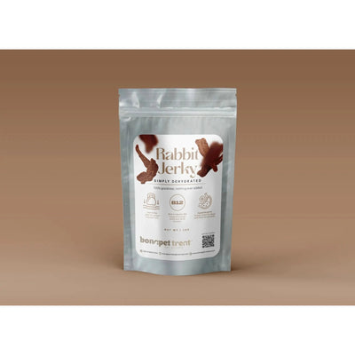 A silver pouch labeled Bonapet Digestible Rabbit Jerky for Dogs with Allergies & Food Sensitivities 4 oz shows dehydrated jerky, nutrition details, and Bonapet Treat branding—ideal as a high-protein or hypoallergenic dog snack.