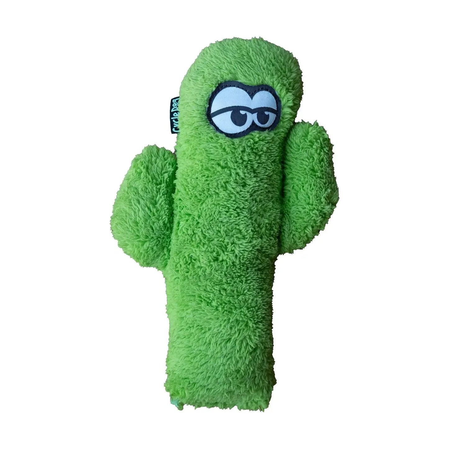 The Cycle Dog Duraplush Eco-Friendly Tough Dog Toy is a green plush cactus with two arms, side-glancing embroidered cartoon eyes, a soft fuzzy texture, and a small fabric tag on the left.