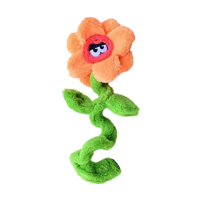 The Cycle Dog Duraplush Unstuffed Springyflowers Dog Toy by Cycle Dog is shaped like an orange flower with a pink center, cartoon eyes, twisted green stem, and two leaves, shown on a white background.