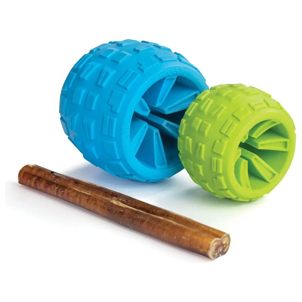 Two eco-friendly dog toys, one large blue and one small green with a tire-like texture, sit beside a brown stick-shaped treat on white—ideal for playtime or fetching with the Cycle Dog High Roller Plus Dog Ball from Cycle Dog.