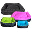 Four rectangular, washable Cycle Dog Waterproof Barrier Nestle Dog Beds in black, pink, green, and blue—each a different size—are neatly arranged with the largest black bed at the back and the smallest blue bed at the front.