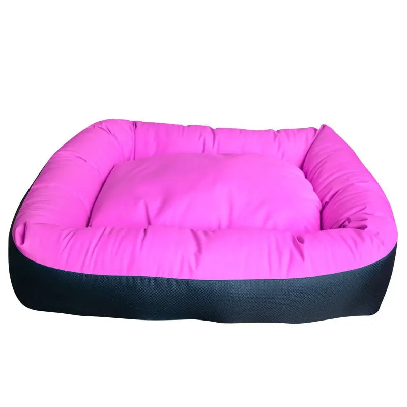 The Cycle Dog Waterproof Barrier Nestle Dog Bed by Cycle Dog is a rectangular, eco-friendly bed with raised sides, a bright pink cushioned interior, and a dark outer base.