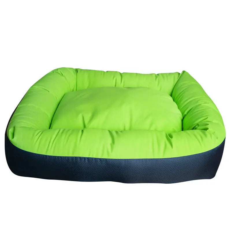 The Cycle Dog Waterproof Barrier Nestle Dog Bed by Cycle Dog is a bright green, square, eco-friendly bed with padded sides, a thick cushion, and a washable dark blue base.