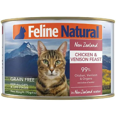 A can of Feline Natural Chicken & Venison Feast Grain-Free Canned Cat Food (12/6oz) features 99% premium meat and organs—cage-free chicken and grass-fed venison—from New Zealand. Label shows a tabby cat before mountains.