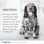 A black and white dog sits on a clean floor with its tongue out. Next to the dog is Four Paws Magic Coat Cleanse & Conditions 2-in-1 Dog Shampoo and Conditioner, with directions to wet, lather, rinse, and repeat as needed.