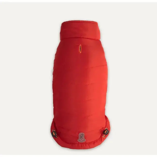 The Goo-Eez Mock Neck Signature Dog Jacket by Goo-Eez is a bright red, padded jacket featuring a high collar, small harness opening near the top, and two buttoned flaps at the bottom.