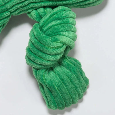 Close-up of the HuggleHounds Durable Plush Corduroy Knottie Squeaky Dog Toy in green. This soft, ribbed toy features a knotted design, visible stitching, and a velvety texture. Shown against a plain light background.