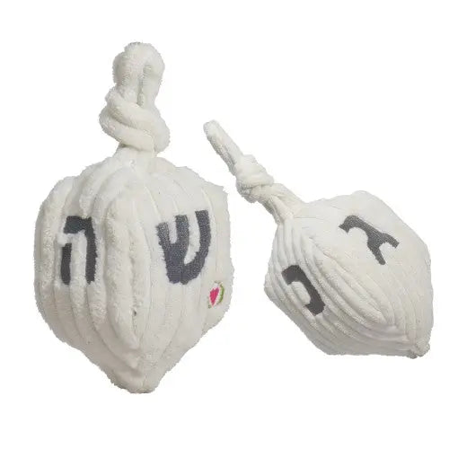 The HuggleHounds Shining Collection Dreidel Durable Plush Dog Toy by HuggleHounds features plush white dreidels with Hebrew letters and knotted tops—an ideal festive dog toy for Hanukkah celebrations.